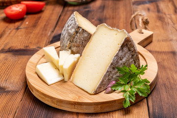 Cheese tomme de montagne or tomme de savoie made from cow milk in French Alps.