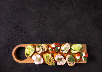 Assorted bruschetta with vegetarian fillings. Mix the bruschetta Delicious bruschetta or crostini. Variety of small sandwiches. 