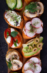 Delicious bruschetta or crostini. Assorted bruschetta with vegetarian fillings. Variety of small sandwiches. Mix the bruschetta