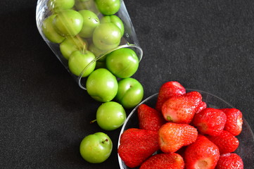 strawberries and cherry plum in a glass