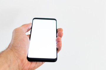 Smartphone blank with hand and fingers tap on screen with white background. Smartphone mockup with...