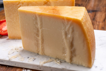 Big wedges of parmigiano-reggiano parmesan hard Italian cheese made from cow milk or Grana Padano