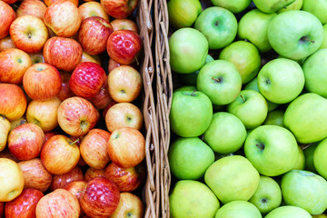 red, green apples on boxes in supermarket. Apples being sold at public market. Organic food