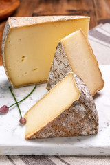 Cheese tomme de montagne or tomme de savoie made from cow milk in French Alps.