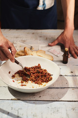 Chef making beef steak tartare raw egg yolk