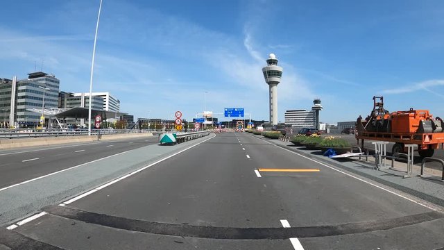 SCHIPHOL, NETHERLANDS - MAY 8, 2020: POV driving at abonded access road to airport departures during coronacrisis