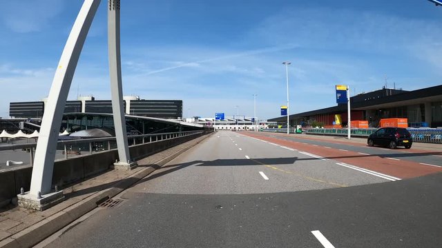SCHIPHOL, NETHERLANDS - MAY 8, 2020: POV driving at abonded access road to the airport during coronacrisis