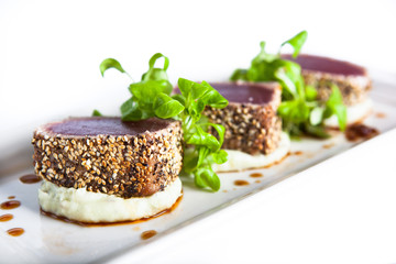 Seared Ahi Tuna with garnish on mashed potato base