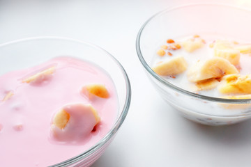 Breakfast for health and diet muesli flakes with bananas and milk and yogurt in a bowl.