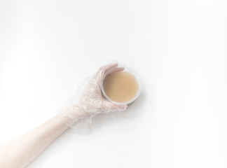 Close up of medical experiments. transparent jar, three pockets with reagents, medical gloves on...