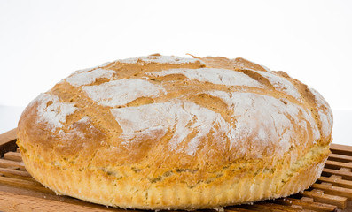 Freshly baked homemade bread on bread board.