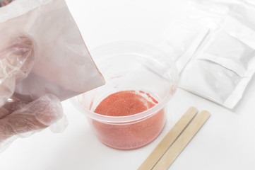 Close up of medical experiments. transparent jar, three pockets with reagents, medical gloves on...