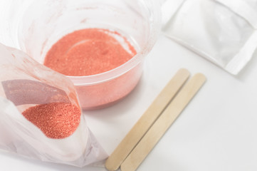 Close up of medical experiments. transparent jar, three pockets with reagents, medical gloves on isolated light background. Experiments for kids. Selective focus