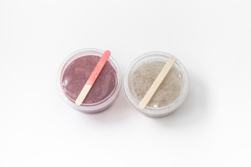 Close up of medical experiments. transparent jar, three pockets with reagents, medical gloves on isolated light background. Experiments for kids. Selective focus