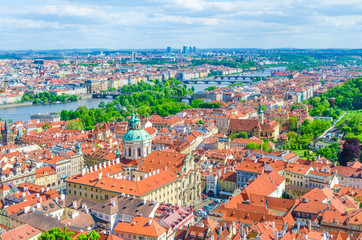 Fototapeta na wymiar Top aerial panoramic view of Prague historical city centre with red tiled roof buildings in Mala Strana Lesser Town and Smichov districts, bridges over Vltava river, Bohemia, Czech Republic
