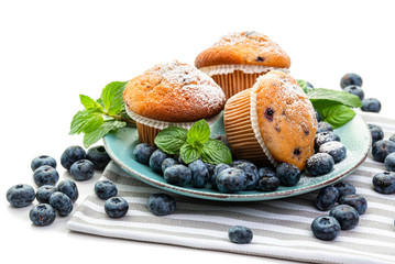 Blueberry Muffins and fresh blueberries on a blue plate