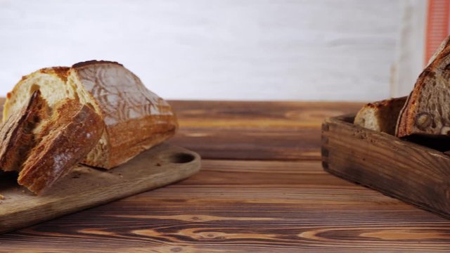 Wooden bread boards with various types of sliced bread.