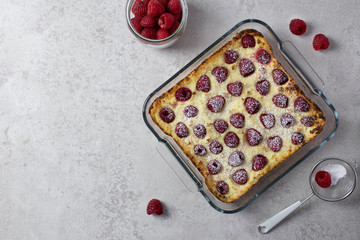 Homemade casserole with cottage cheese, semolina and raspberries. Sweet cake with icing sugar. Top view. Flat Lay. Copy space.