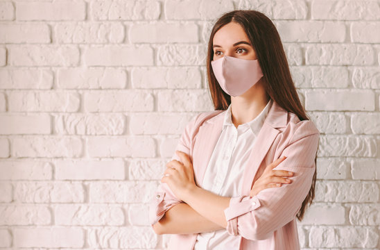 Portrait Young Confident Professional Business Woman In Pink Suit And Medical Face Mask With Arms Crossed. Happy Beautiful Girl Lawyer In Stylish Protective Face Mask. Female Executive Boss Smiling