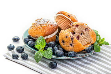 Blueberry Muffins and fresh blueberries on a blue plate