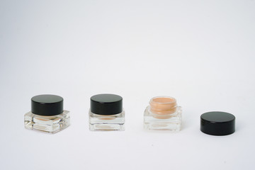 eye shadow cream in glass bottles on isolated white background with copy space