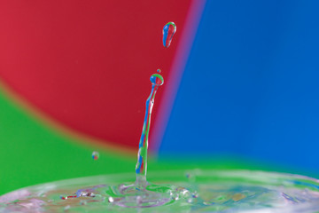 macro photography of water drops with blue-green and red background