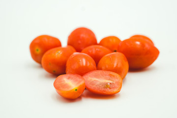 Tomato cherry shot on a white isolated background.