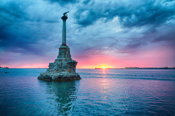 Monument to the flooded ships against the backdrop of the beautiful cloudy sunset. Sevastopol,...
