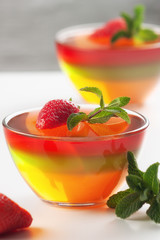 Fruit jelly with strawberries on a white table