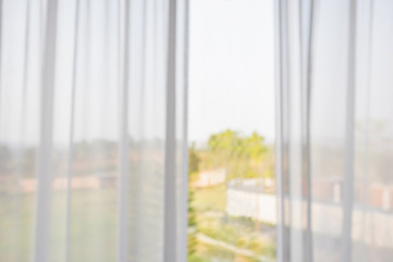 window curtain with green garden abstract blur background