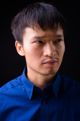 Fototapeta premium Portrait of young Asian businessman thinking and looking away