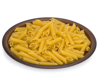 Italy dry raw pasta penne rigate on the plate. Closeup on a white background