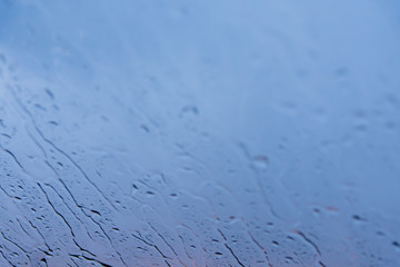 sky view through car window with rain drops