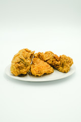 Deep fried chicken shot on a white isolated background.