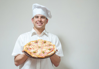 portrait cook with pizza on a light background