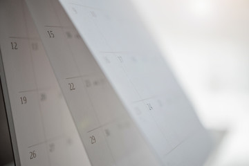 calendar page flipping sheet close up on wood table background business planning appointment...