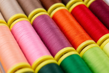 Sewing threads of many colors seen from close up