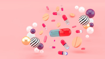 Medicine capsule surrounded by colorful balls on a pink background.-3d rendering.
