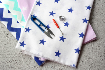 Obraz premium Natural fabric. Graphic cotton. Bright fabrics and sewing tools. Concept - handicraft, making clothes.