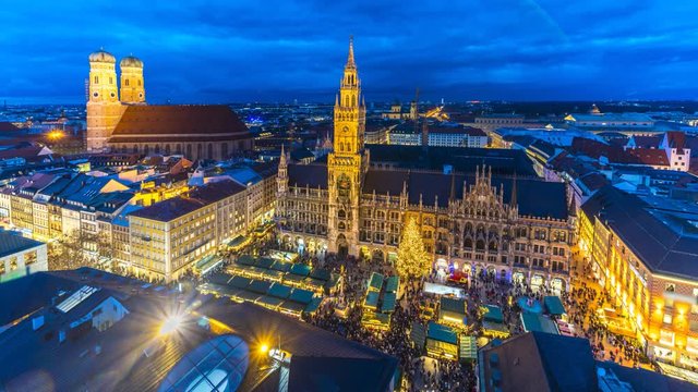 Munich skyline at night top view of christmas market at marienplatz square people shopping in winter bavaria germany. Munchen Night city centre town hall, church and most popular square panorama view.