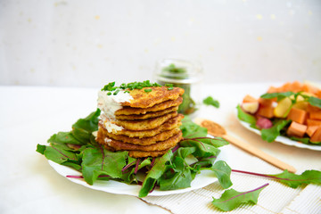 potato patties stacked with fresh herbs.
