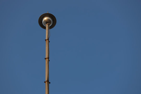 Photo of the top of the lightning rod, background blue sky. Close up.