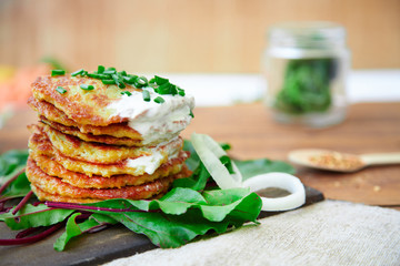 potato patties stacked with fresh herbs.