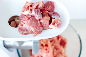 Meat in a meat grinder. Food preparation. Meat for cutlets. Production. Minced meat.