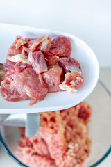 Meat in a meat grinder. Food preparation. Meat for cutlets. Production. Minced meat.