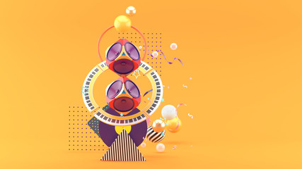 The speaker is surrounded by a piano, amidst colorful balls on an orange background.-3d rendering..