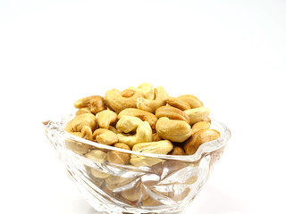 Cashew in a glass bowl, isolated on a white background, healthy protein and good fat source