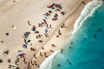 Top view of Shipwreck Beach with bathers, white sand and clear turquoise water in Zakynthos, Ionian Islands, Greece.