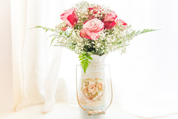 Culture Pearls on Fresh Pink Roses and Gypsophila Bouquet in Shabby Chic Vintage Vase