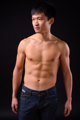 Fototapeta na wymiar Portrait of young muscular Asian man shirtless